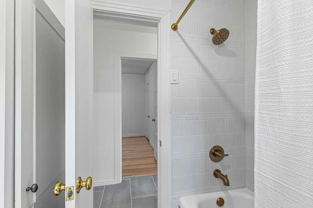 Full bath - tub and brass fixtures