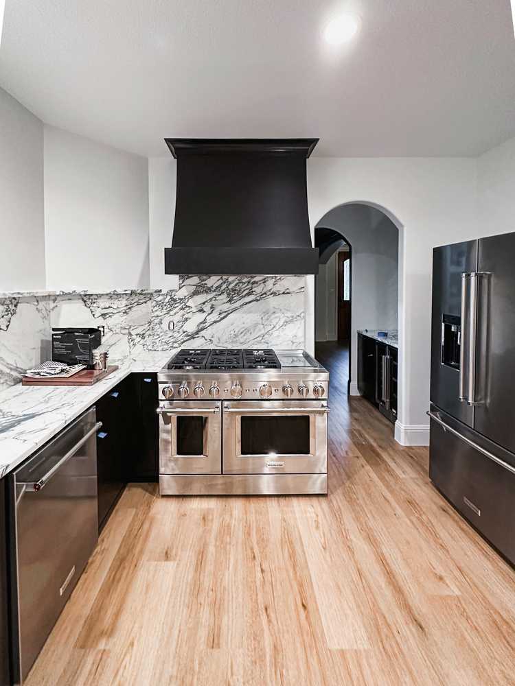 Custom kitchen - marble backsplash and statement hood
