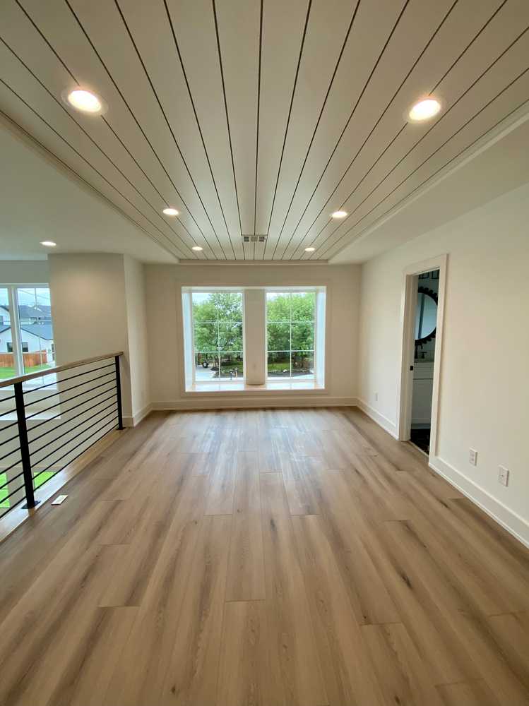 Living space - shiplap ceiling and black windows